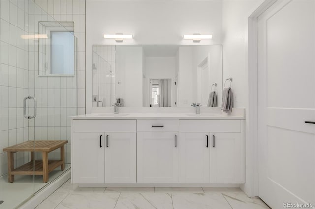 bathroom with vanity and a shower with door