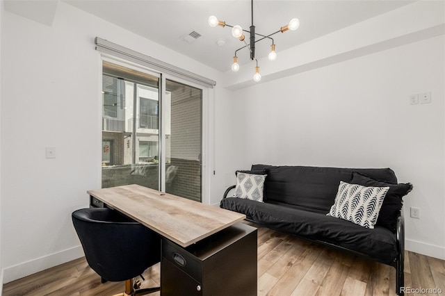 home office with a chandelier and wood-type flooring