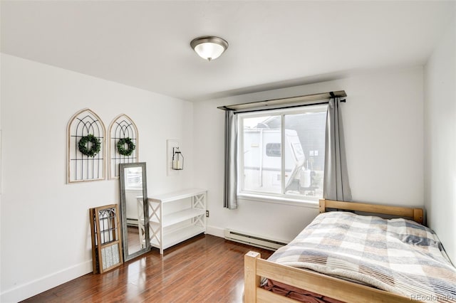 bedroom featuring dark wood-type flooring and a baseboard radiator