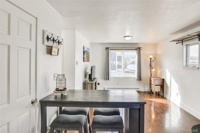 bar featuring baseboard heating and dark wood-type flooring