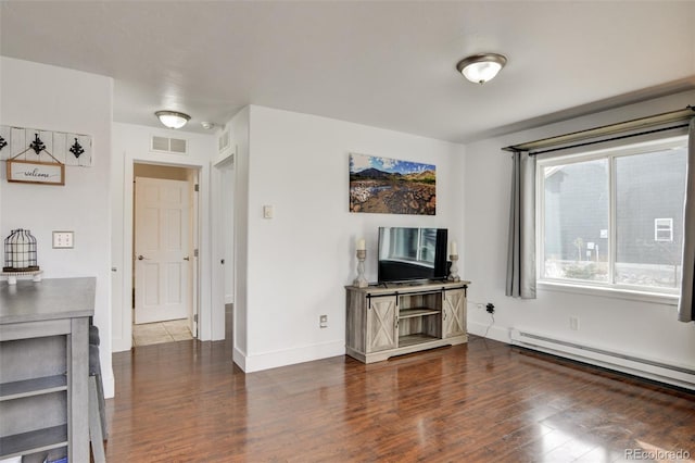 living room featuring dark hardwood / wood-style flooring and baseboard heating