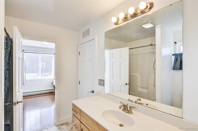 bathroom featuring vanity, tile patterned flooring, a shower with curtain, and baseboard heating