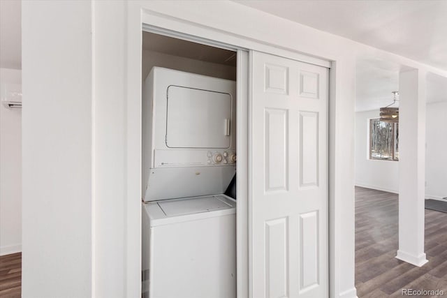 clothes washing area with stacked washer / dryer and dark wood-type flooring