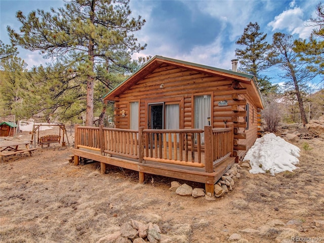 back of property featuring a wooden deck