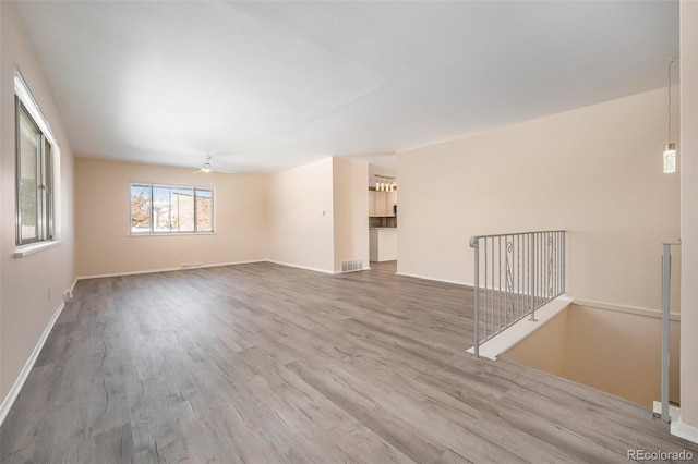 empty room featuring hardwood / wood-style flooring and ceiling fan