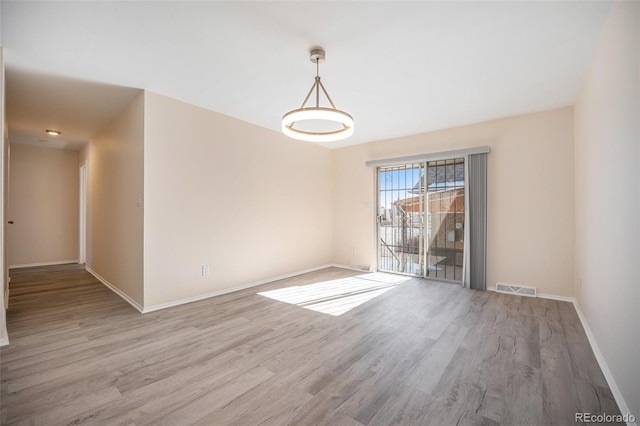 spare room featuring hardwood / wood-style flooring