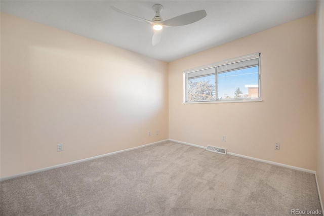 carpeted spare room featuring ceiling fan