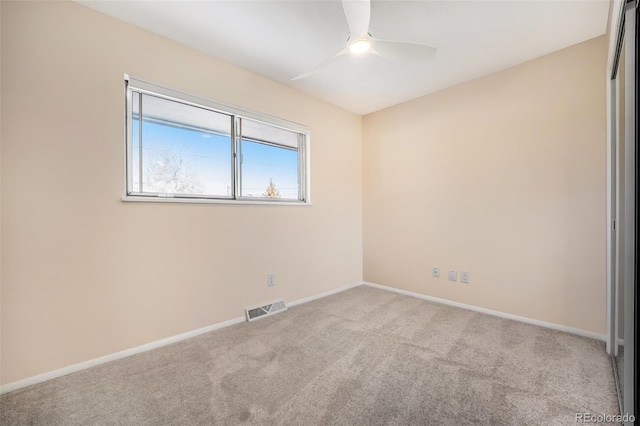 carpeted empty room with ceiling fan