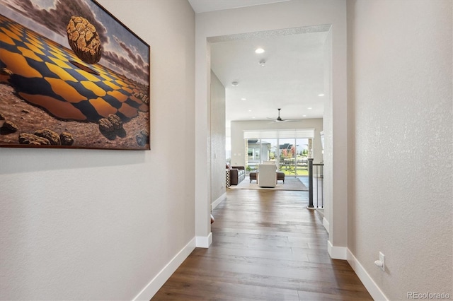 hallway featuring recessed lighting, wood finished floors, and baseboards