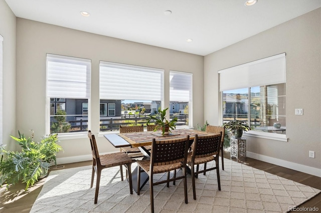 dining space with recessed lighting, baseboards, and wood finished floors