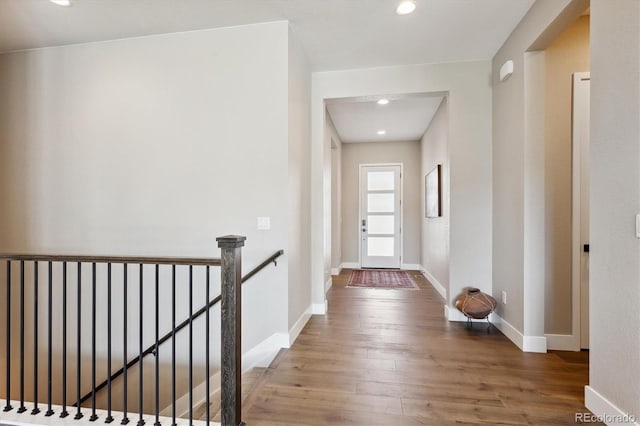 doorway to outside featuring recessed lighting, wood finished floors, and baseboards