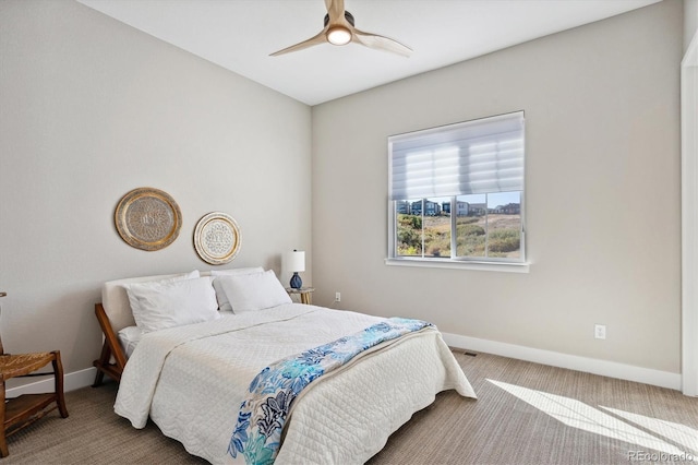 carpeted bedroom featuring ceiling fan, visible vents, and baseboards