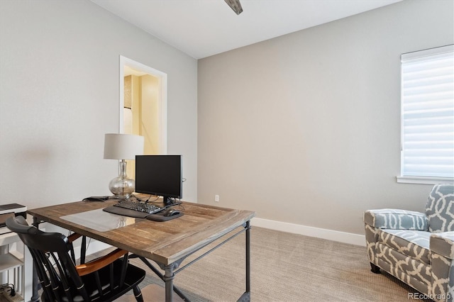 office featuring light carpet and baseboards