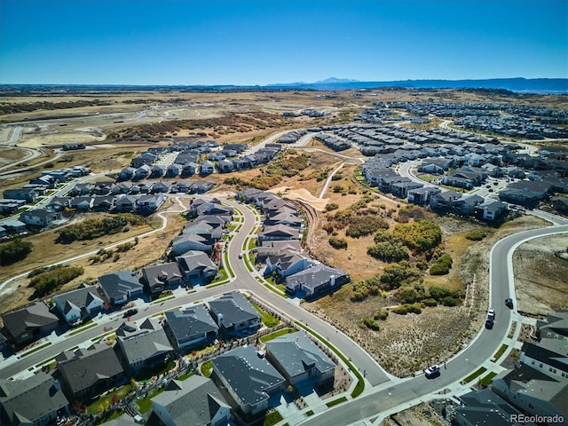 drone / aerial view featuring a residential view and a mountain view