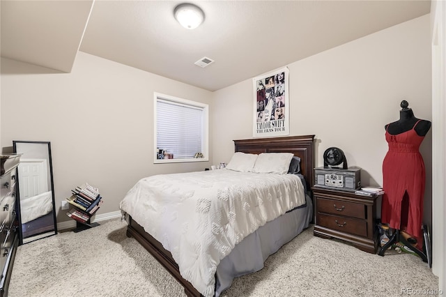 bedroom featuring baseboards, visible vents, and light carpet