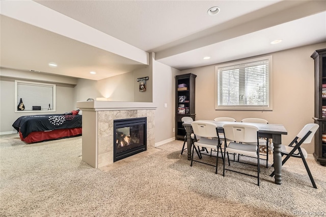 carpeted dining room with recessed lighting, a tile fireplace, and baseboards