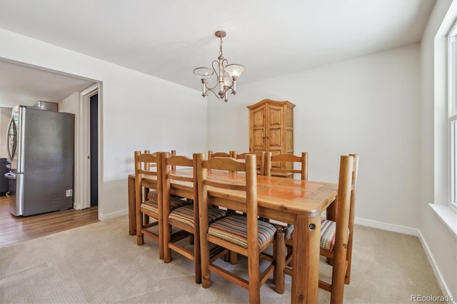 8445 Lamar Dr, Arvada, CO 80003 - dining area with light colored carpet and a chandelier