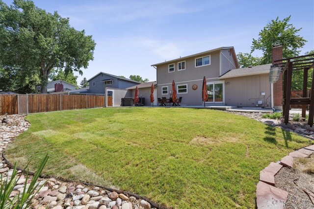 8445 Lamar Dr, Arvada, CO 80003 - rear view of property featuring a fenced backyard and a patio