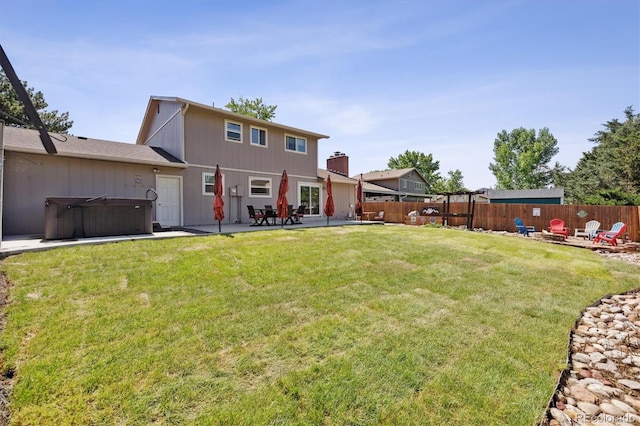 8445 Lamar Dr, Arvada, CO 80003 - rear view of property with a hot tub, a patio, and a fenced backyard
