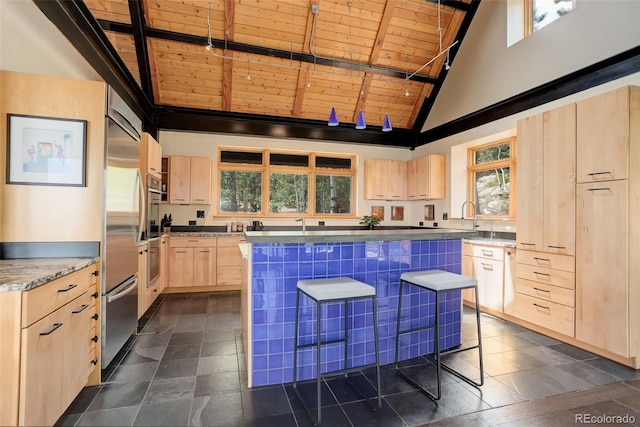 116 Ramona Rd, Golden, CO 80403 - kitchen featuring light brown cabinetry, high vaulted ceiling, wood ceiling, healthy amount of natural light, and a center island