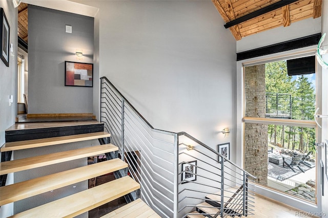 116 Ramona Rd, Golden, CO 80403 - stairway featuring beamed ceiling, wood ceiling, and wood finished floors