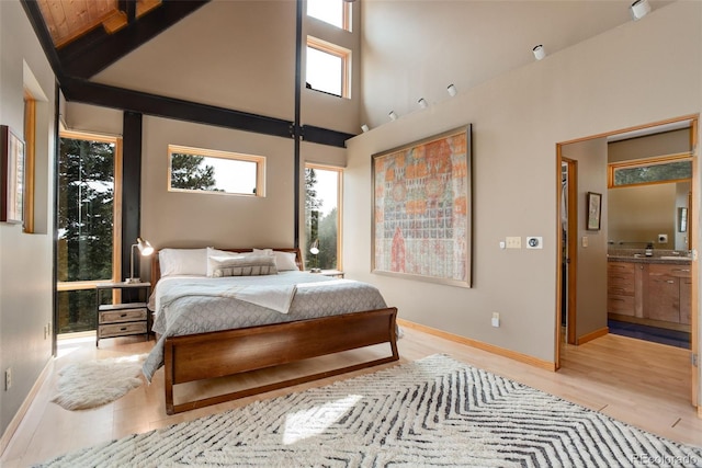 116 Ramona Rd, Golden, CO 80403 - bedroom featuring multiple windows, a high ceiling, light wood finished floors, and baseboards