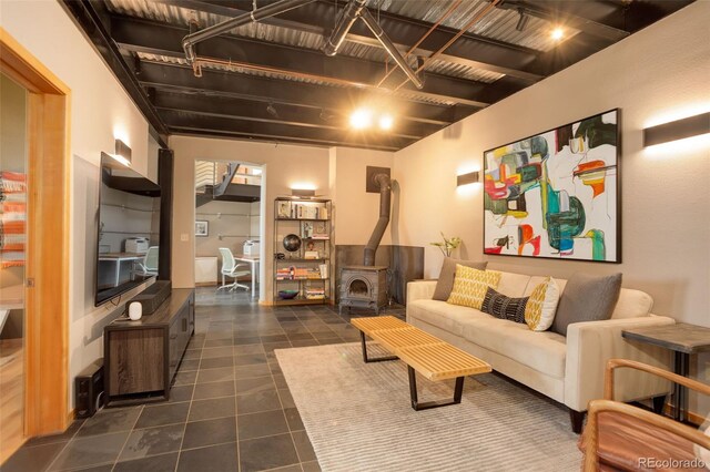 116 Ramona Rd, Golden, CO 80403 - living area featuring a wood stove and dark tile patterned flooring