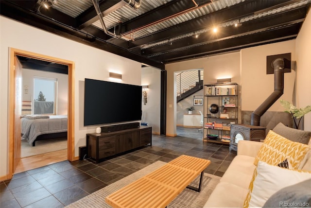 116 Ramona Rd, Golden, CO 80403 - living area with track lighting, a wood stove, baseboards, and stairway