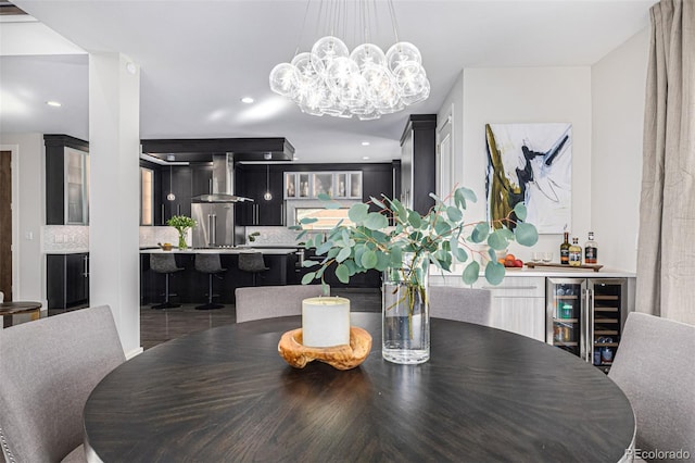 dining space with wine cooler, a bar, and an inviting chandelier