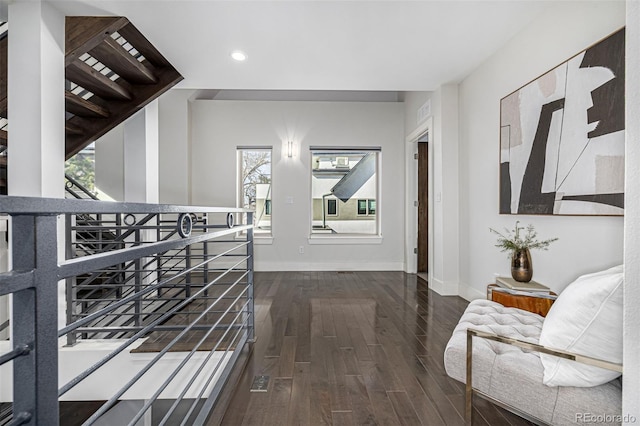 hall with recessed lighting, baseboards, and dark wood-style flooring