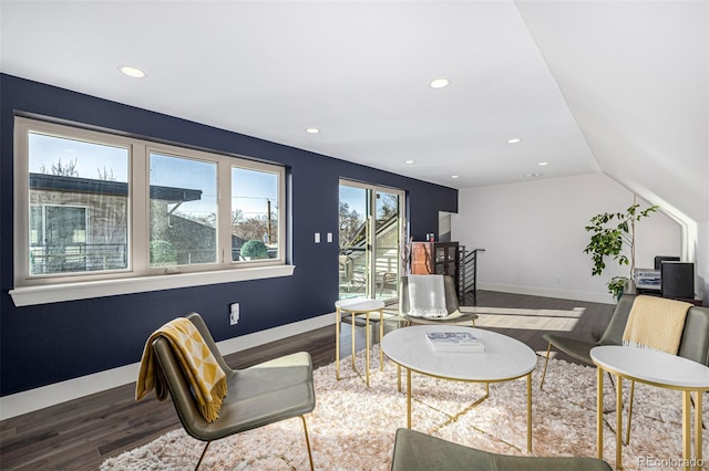 living room featuring recessed lighting, lofted ceiling, baseboards, and wood finished floors