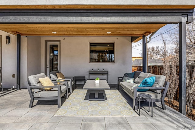 view of patio / terrace with an outdoor living space and fence