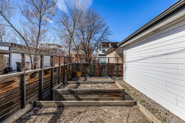 view of yard with fence and a garden