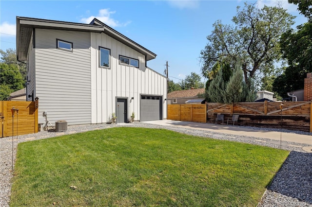 4312 Xavier St, Denver, CO 80212 - view of side of home with board and batten siding, driveway, a garage, and central AC unit