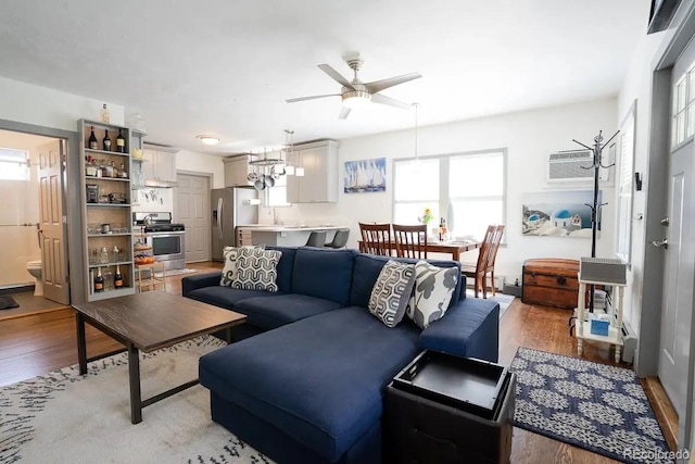 4312 Xavier St, Denver, CO 80212 - living area featuring ceiling fan, light wood finished floors, and an AC wall unit