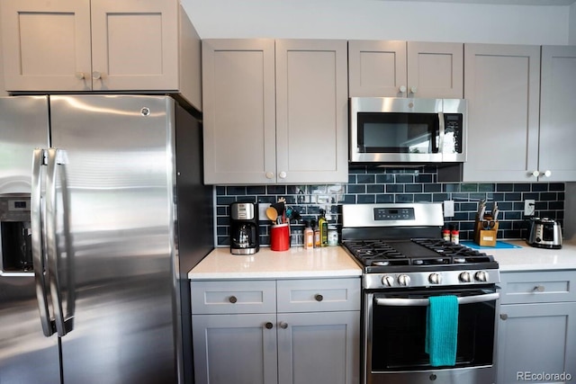 4312 Xavier St, Denver, CO 80212 - kitchen with stainless steel appliances, gray cabinetry, backsplash, and light countertops