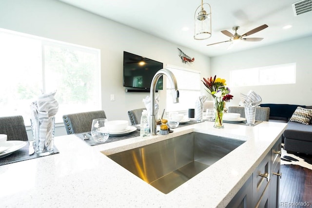 4312 Xavier St, Denver, CO 80212 - kitchen featuring a sink, light stone counters, ceiling fan, pendant lighting, and open floor plan