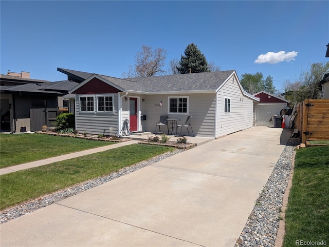 single story home with concrete driveway, an outdoor structure, and a shingled roof