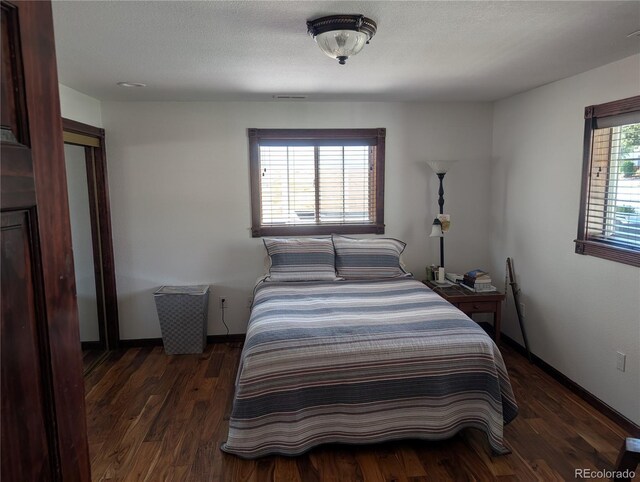 bedroom with wood finished floors and baseboards