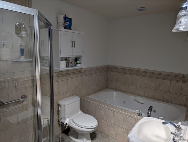 full bathroom featuring a shower stall, a sink, a whirlpool tub, toilet, and tile patterned floors