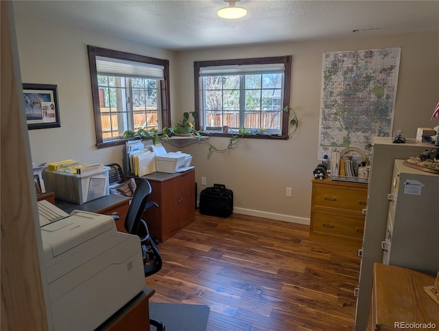 office area with wood finished floors, baseboards, and a textured ceiling