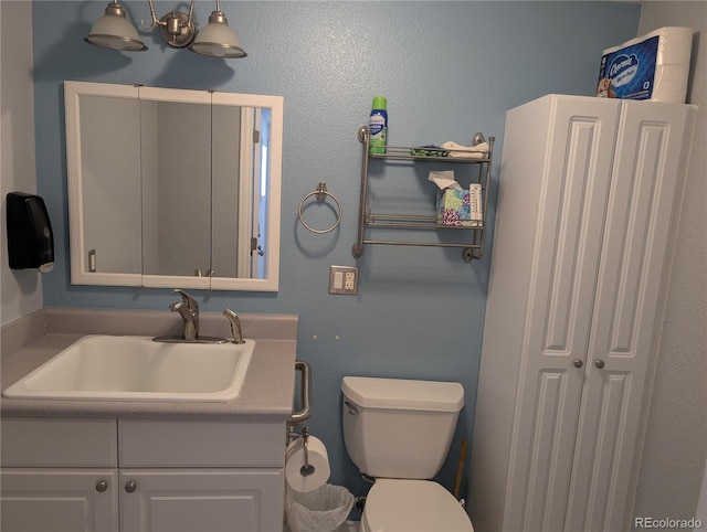 bathroom with toilet and vanity