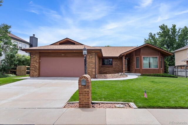 11686 W 74th Way, Arvada, CO 80005 - view of front of property with brick siding, a garage, concrete driveway, and a shingled roof