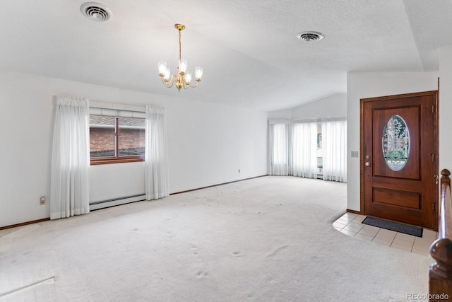 11686 W 74th Way, Arvada, CO 80005 - carpeted entryway featuring baseboard heating, a chandelier, lofted ceiling, and tile patterned flooring