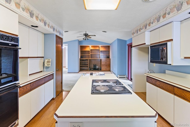 11686 W 74th Way, Arvada, CO 80005 - kitchen featuring black appliances, vaulted ceiling, white cabinetry, light countertops, and ceiling fan