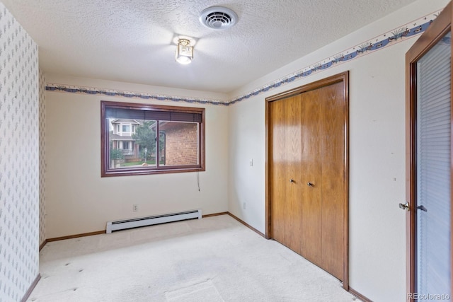 11686 W 74th Way, Arvada, CO 80005 - unfurnished bedroom featuring a baseboard heating unit, light carpet, a textured ceiling, and a closet