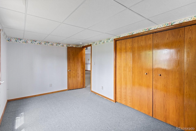 11686 W 74th Way, Arvada, CO 80005 - unfurnished bedroom with a paneled ceiling, a closet, and carpet floors