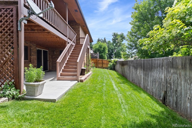 11686 W 74th Way, Arvada, CO 80005 - fenced backyard with stairway, a deck, and a patio area