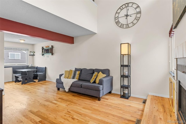 6545 W 84th Way Unit 132, Arvada, CO 80003 - living room featuring wood finished floors, baseboards, and a high ceiling