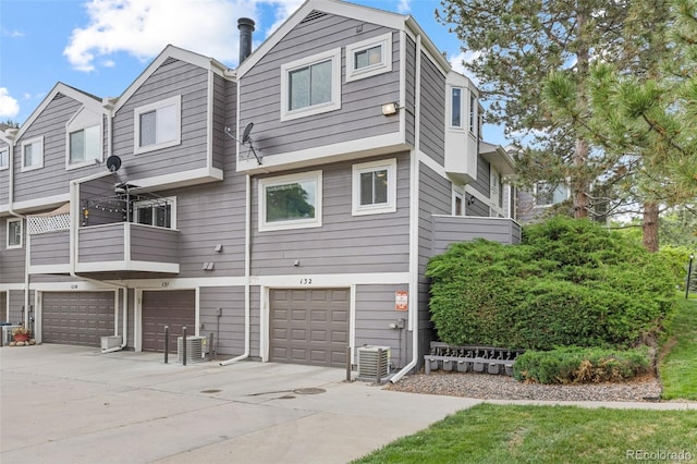 6545 W 84th Way Unit 132, Arvada, CO 80003 - rear view of house with driveway, a garage, and central air condition unit
